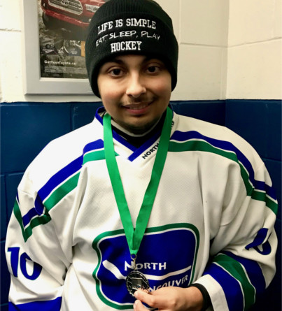 A young hockey player is awarded a medal.
